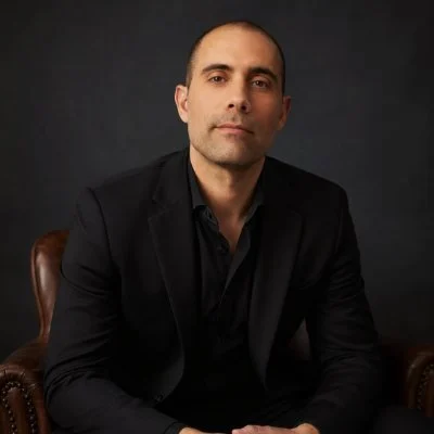 Cliff Marquez, seated in a dark blazer